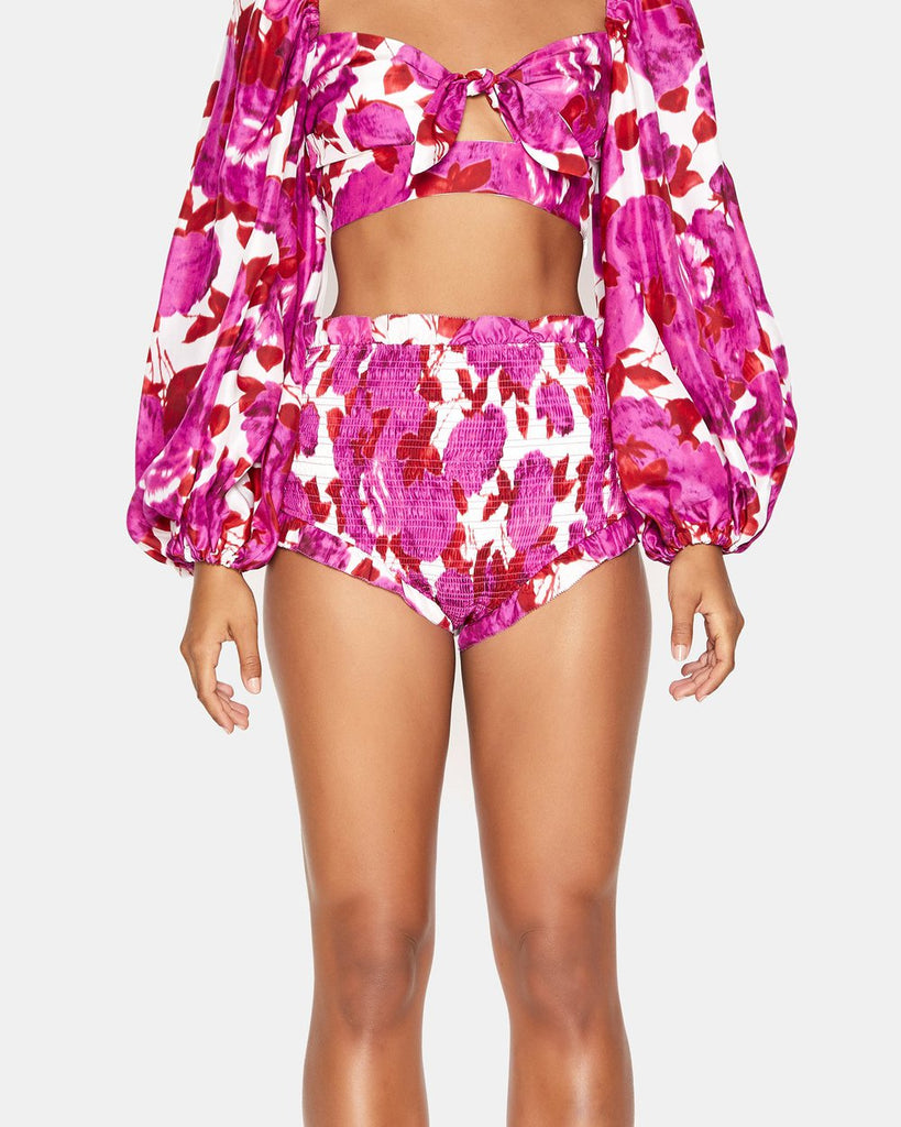 floral design Cropped top features a tie at the bust that creates a small cut out Balloon sleeves that finish with elastic at the cuffs for definition Hot pants features high rise style has been shirred throughout